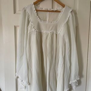 Chloe Cream fluid mine dress. The mini dress is made in silk.